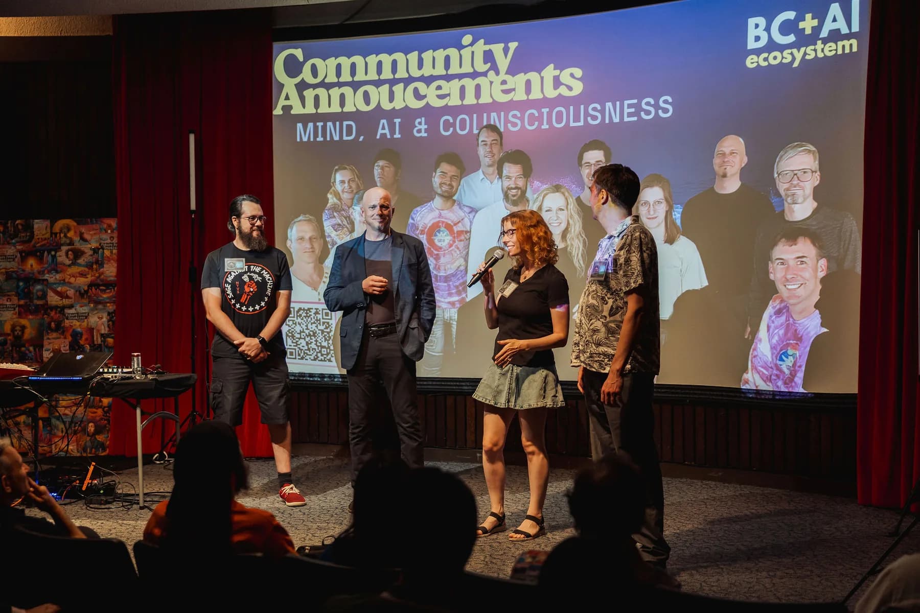 A community announcements stage moment at a July Vancouver AI meetup, screen full of member faces