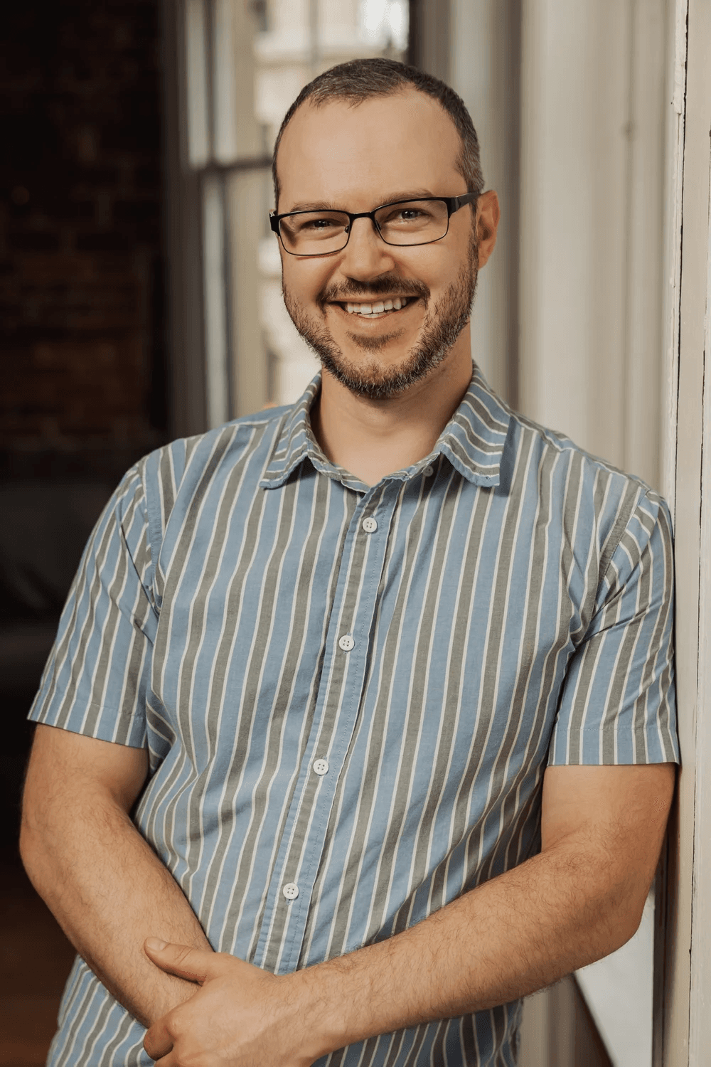 Futureproof Festival featured speaker portrait for Peter Bittner, smiling in a blue-gray striped shirt.