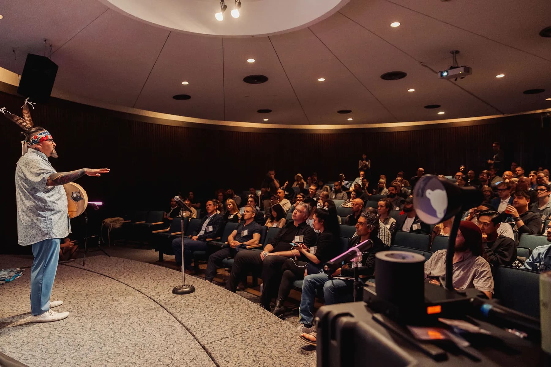 Auditorium speaker facing a packed room