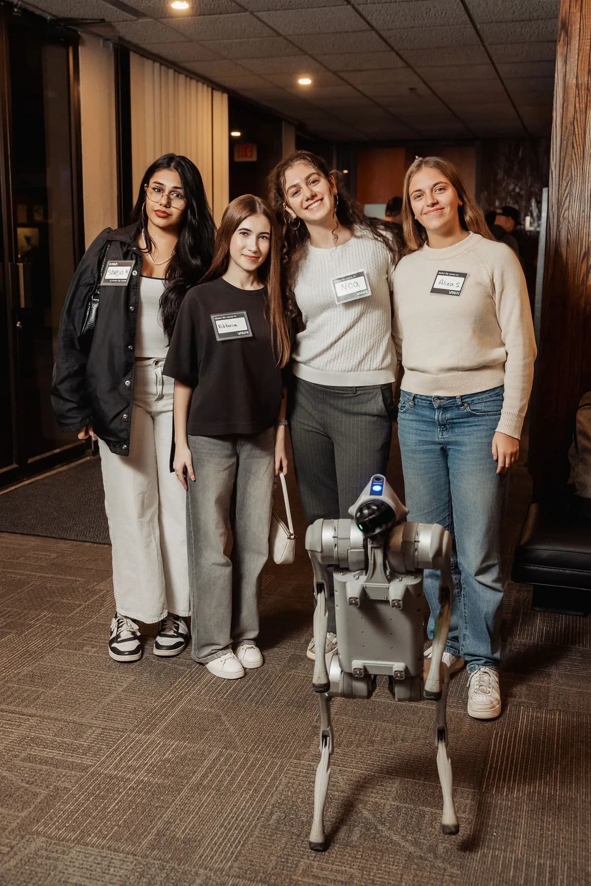 Four young builders standing with a quadruped robot at the Space Centre.