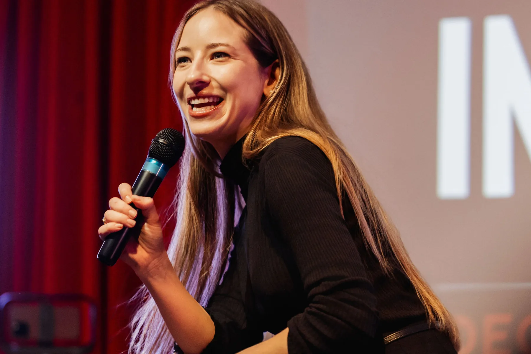 Joyful speaker close-up with a microphone