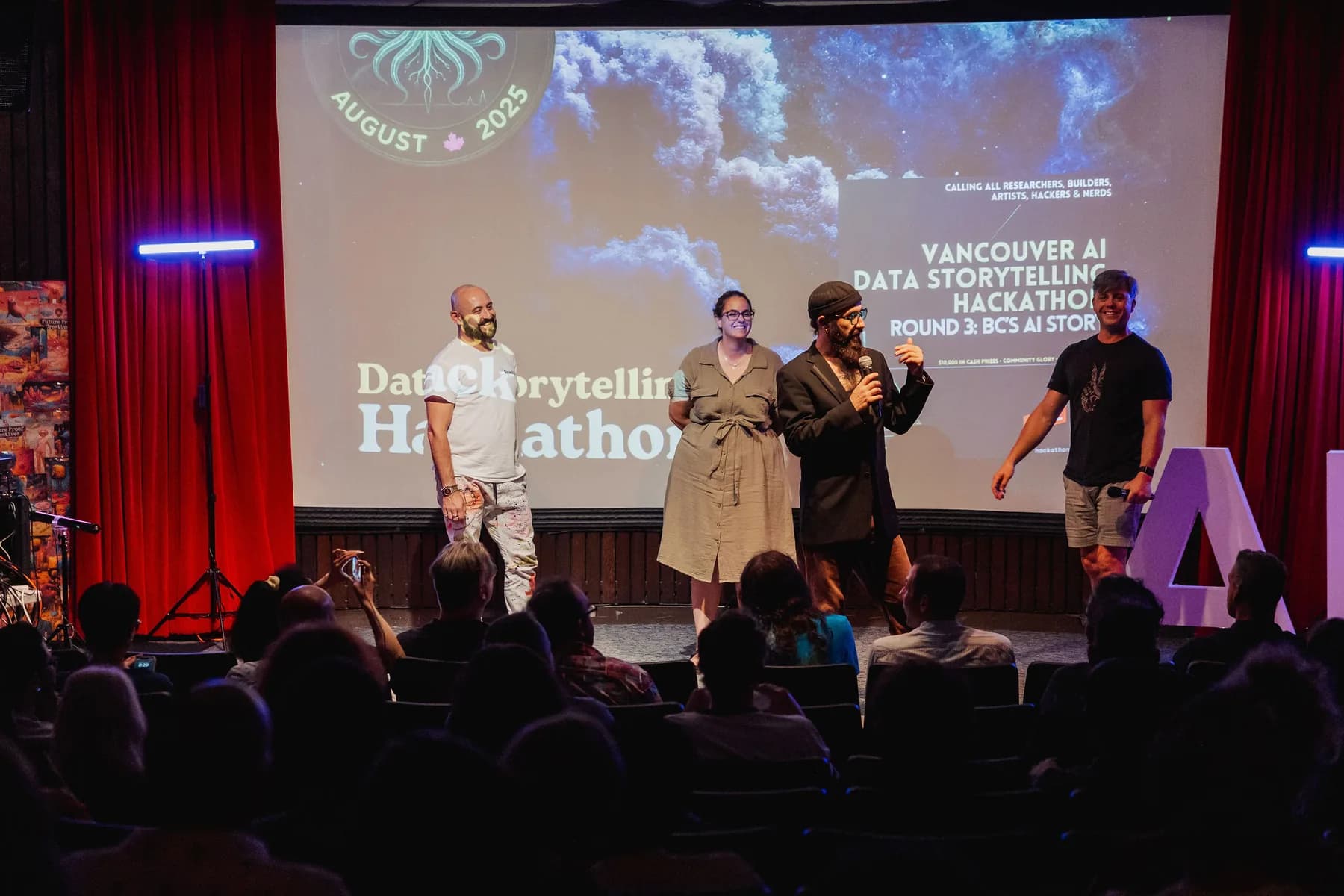 Hackathon finalists gathered on stage beneath a Data Storytelling Hackathon projection.