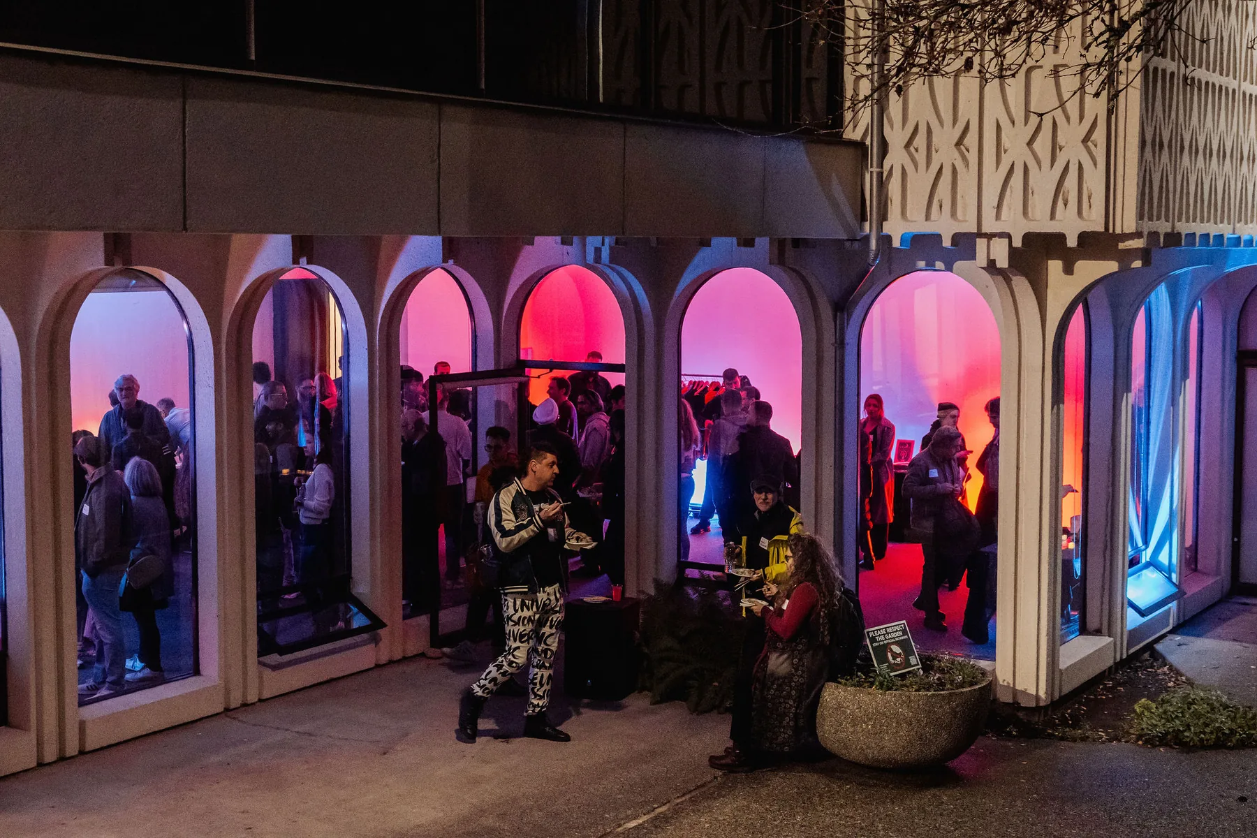 H.R. MacMillan Space Centre exterior at night with people gathered inside